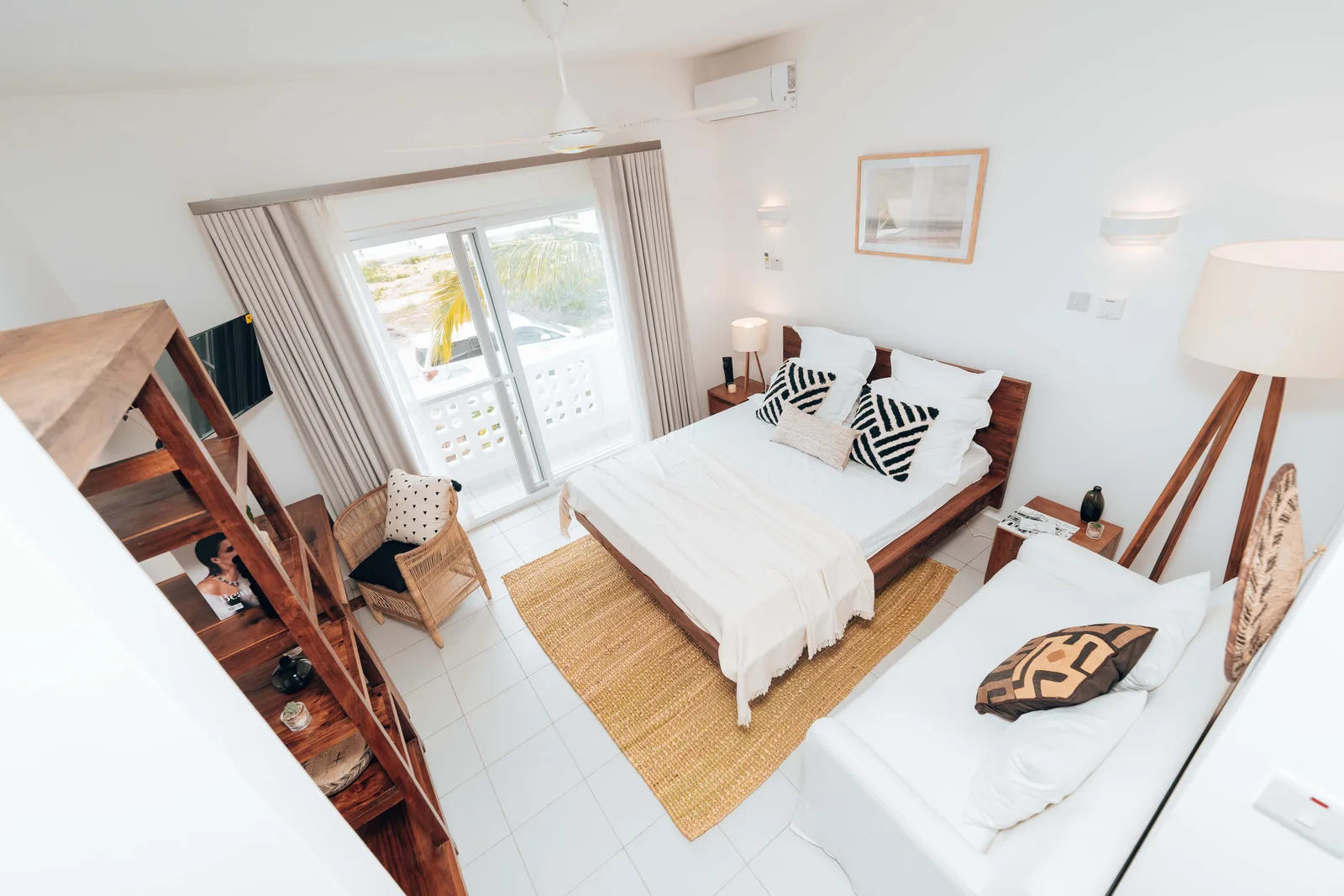 A styled bedroom with white linen in a rental apartment