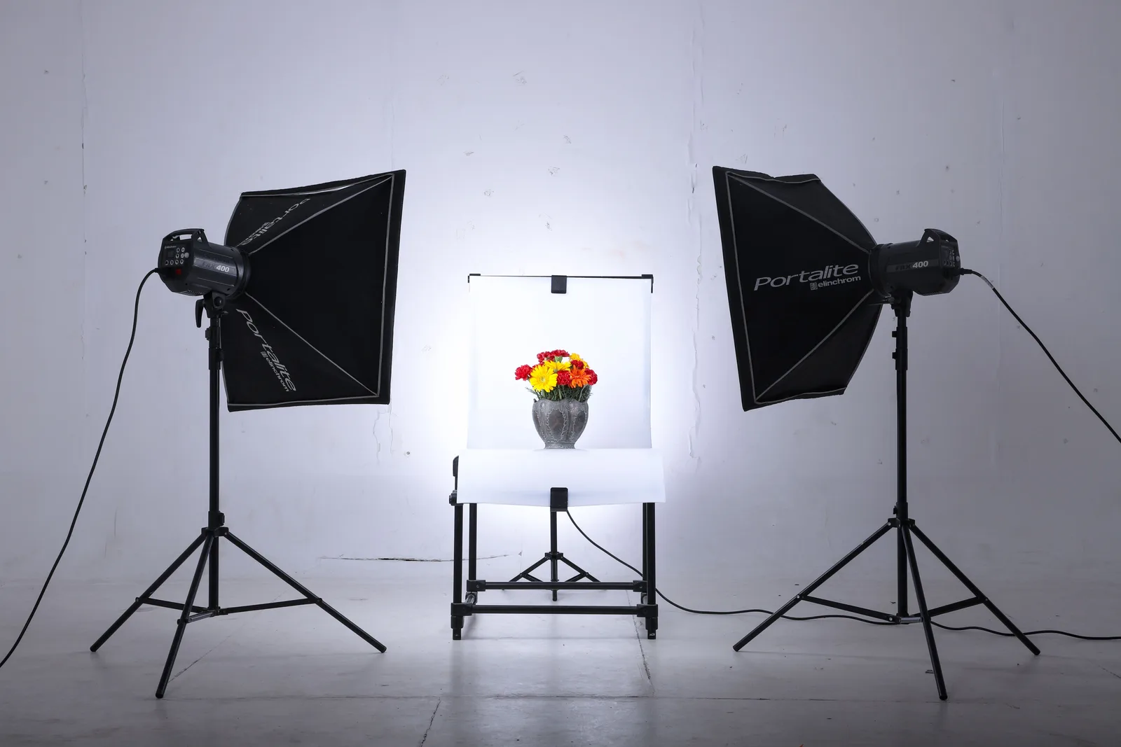 A softbox lighting a subject against a plain background
