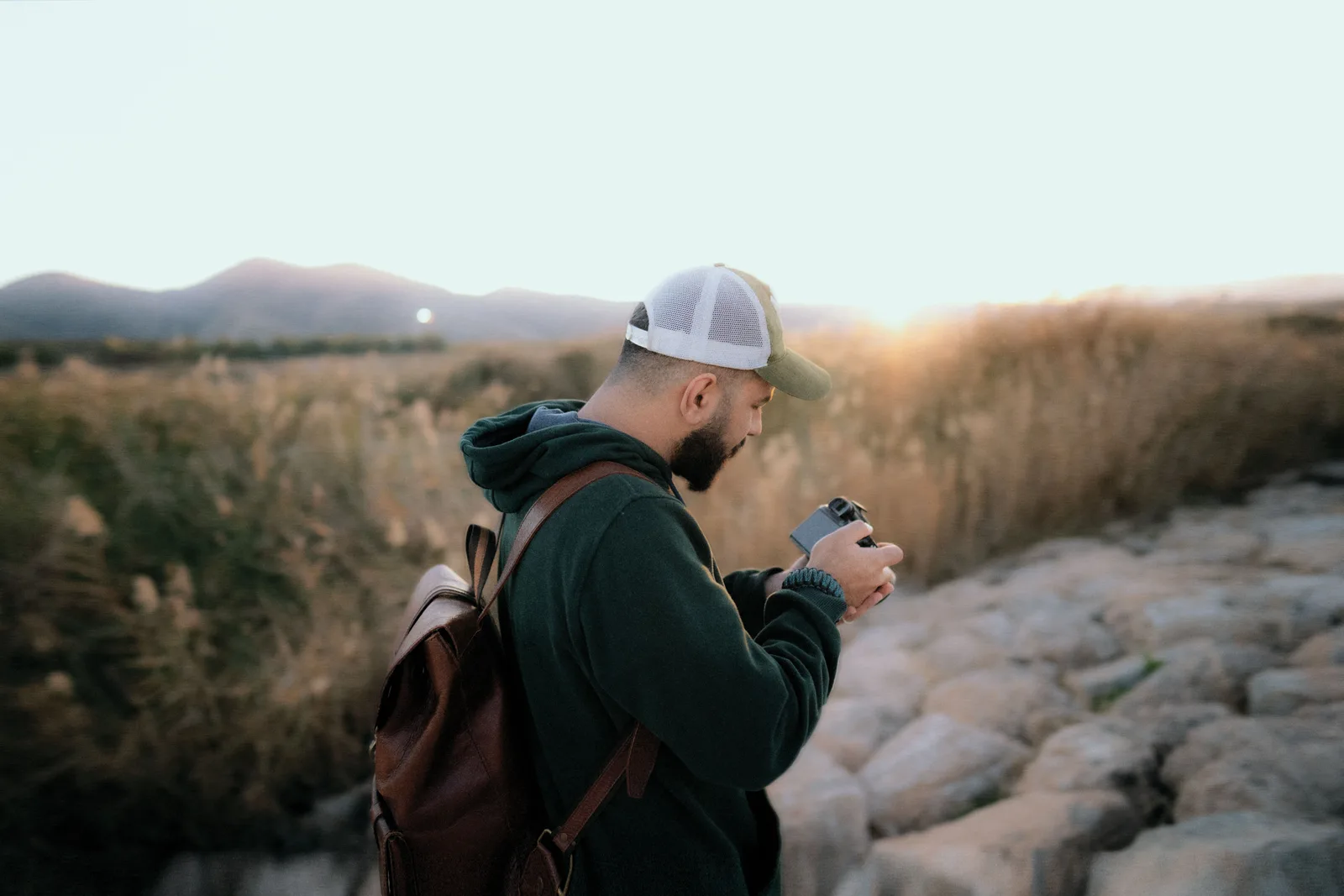 A photographer walking with a camera backpack