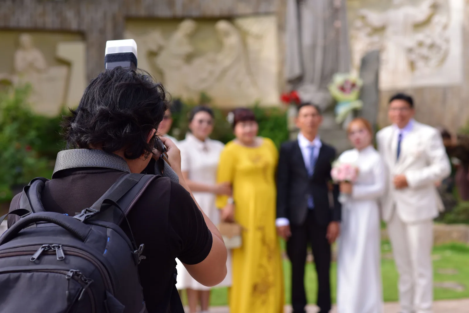 A photographer working at the back of a wedding ceremony