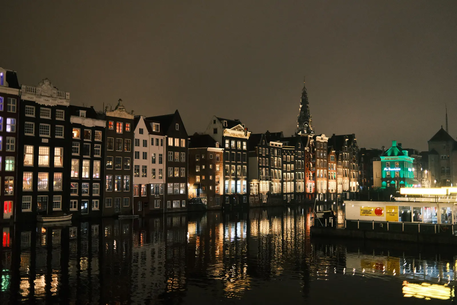 Canal bridge lights reflected in still water after dark