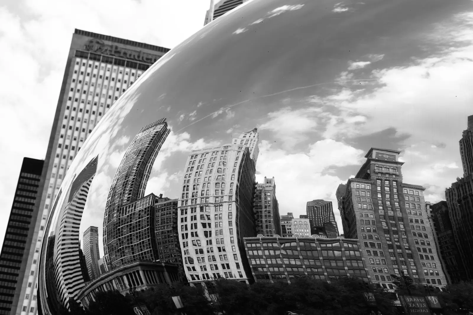 Chicago towers reflected in the curved surface of a sculpture