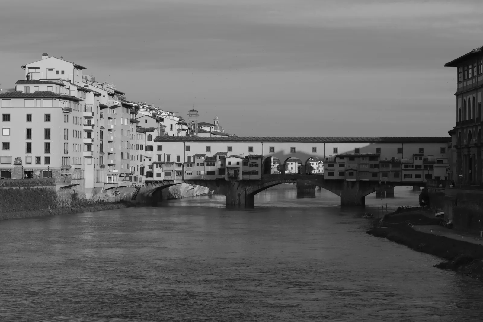 The Ponte Vecchio and its shops seen along the Arno