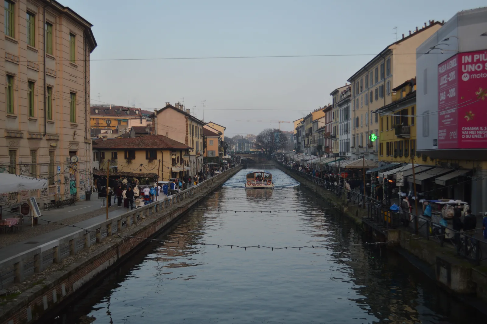 The Navigli canal at dusk with lights reflected in the water