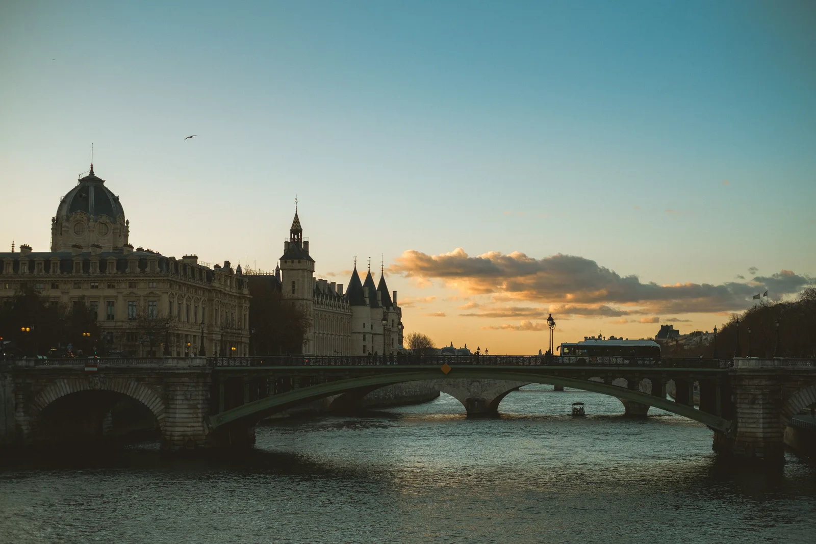 The Seine at dusk with the bridge lamps reflected in the water