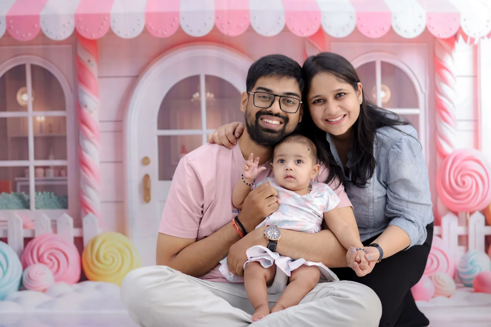 A baby photographed against a plain studio backdrop