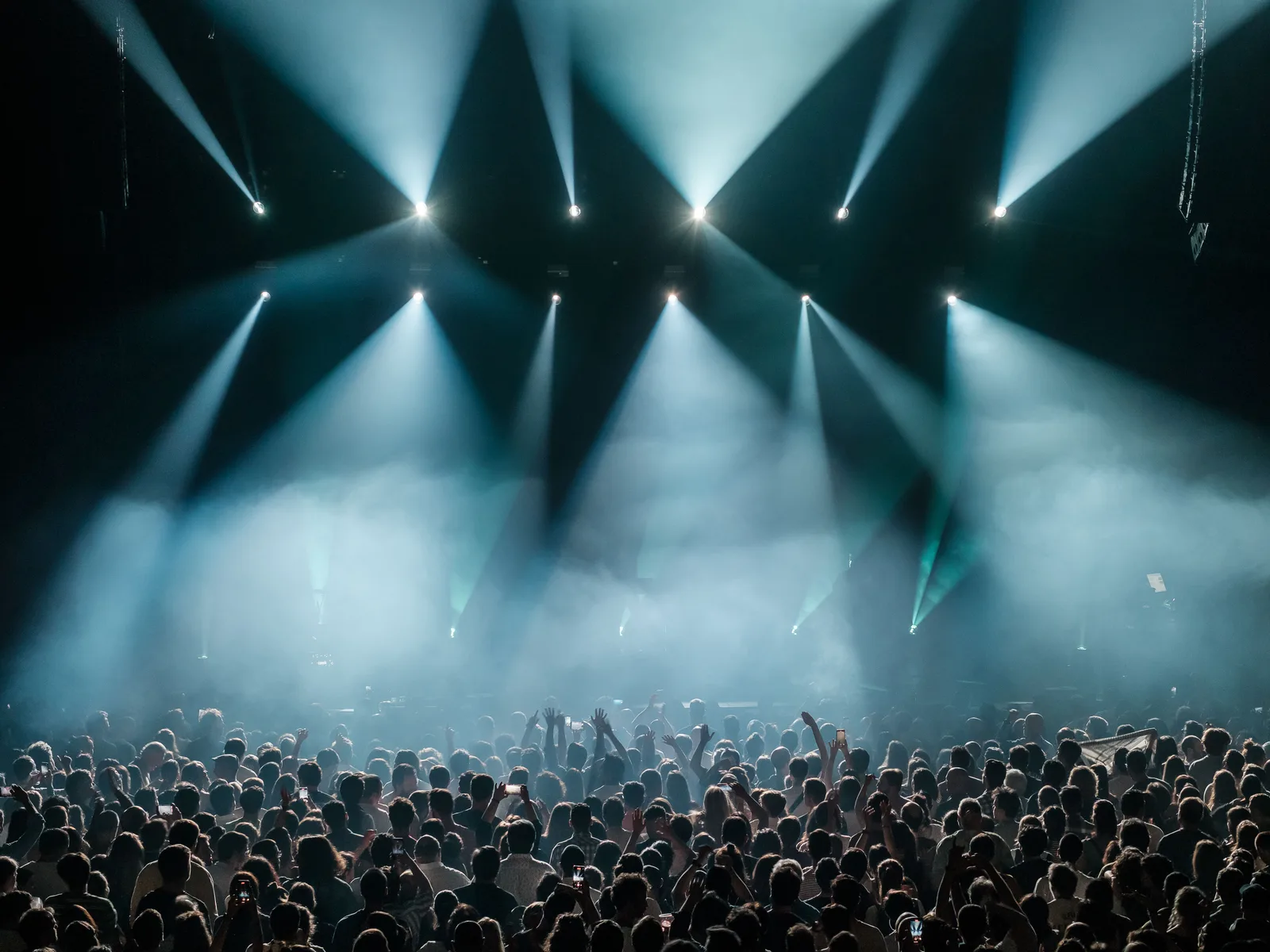 A crowd lit by the stage during a live show