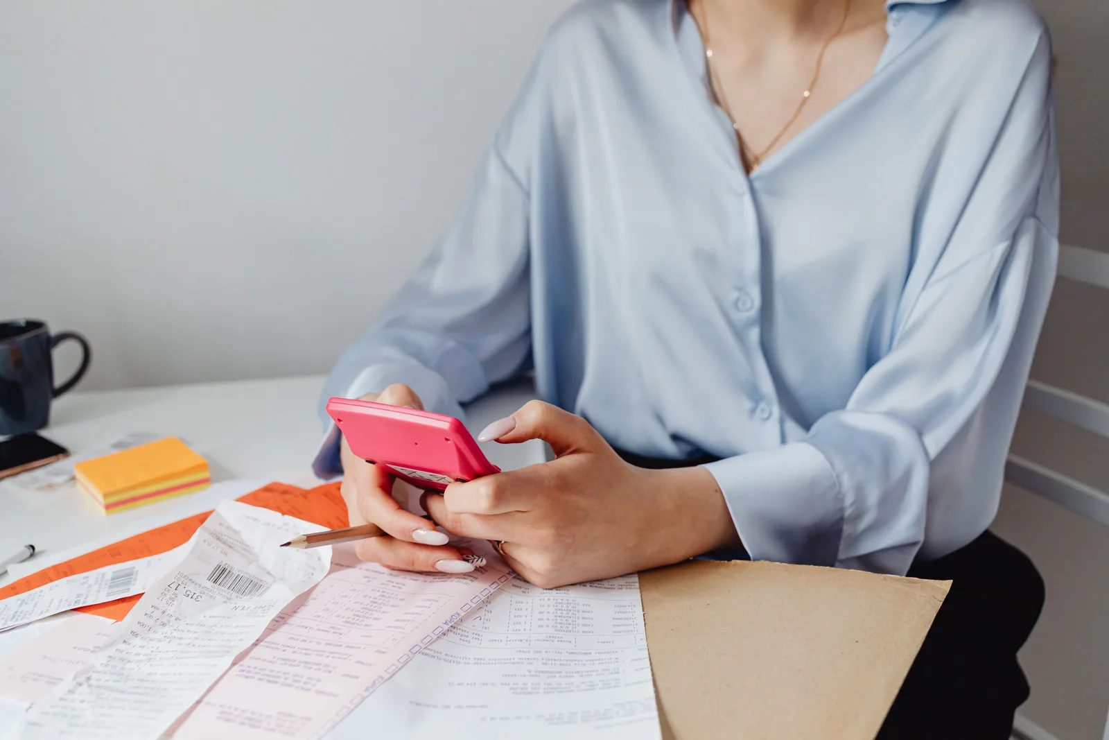 Receipts and a calculator on a desk while working out costs