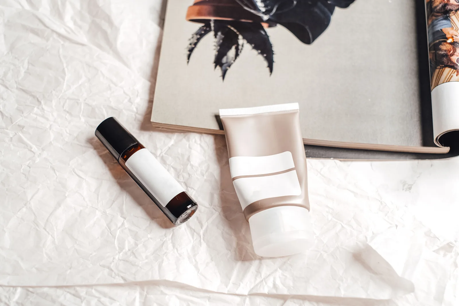 Skincare bottles styled on a stone surface with props for a lifestyle product photograph