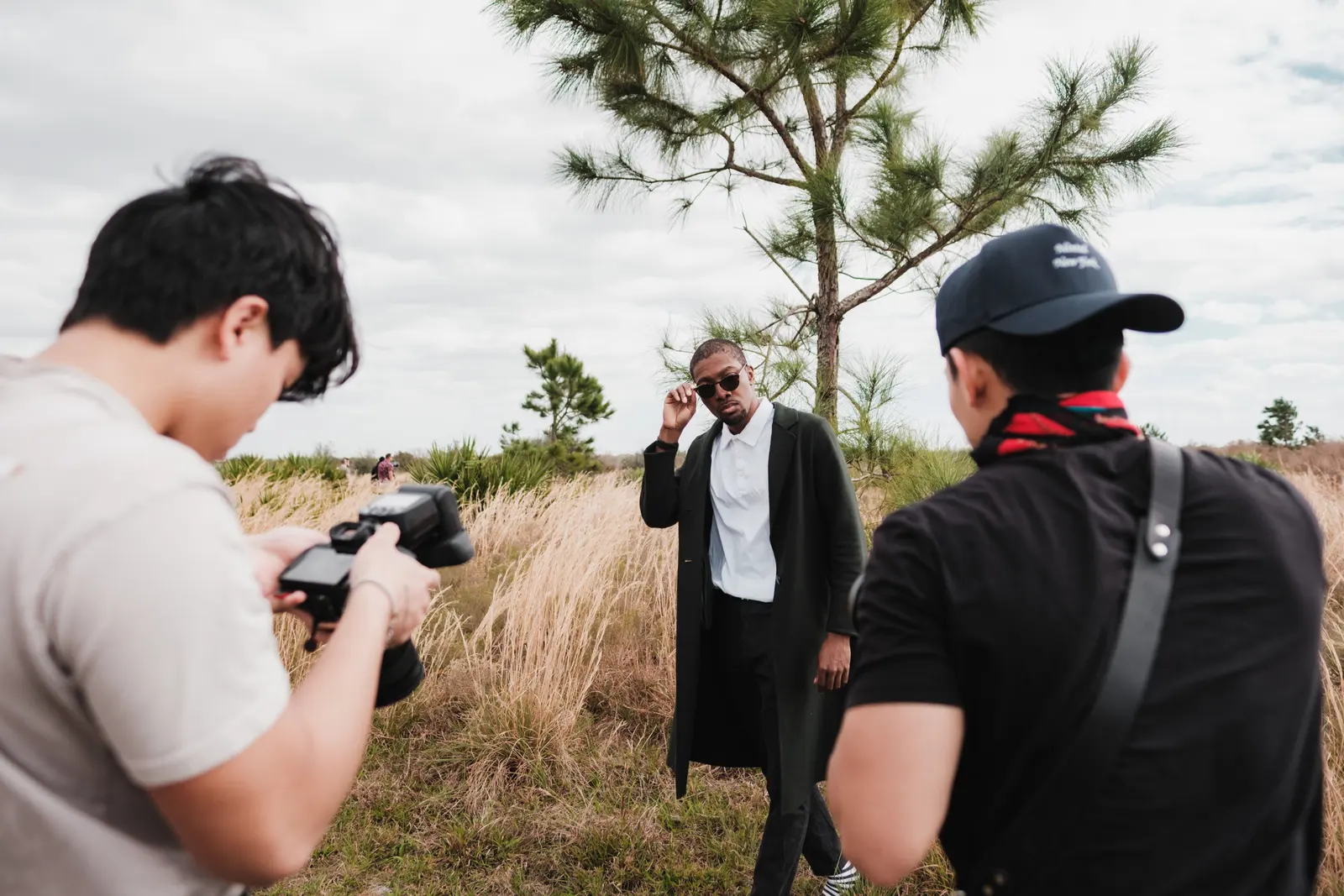 A photographer directing someone during a portrait session outdoors