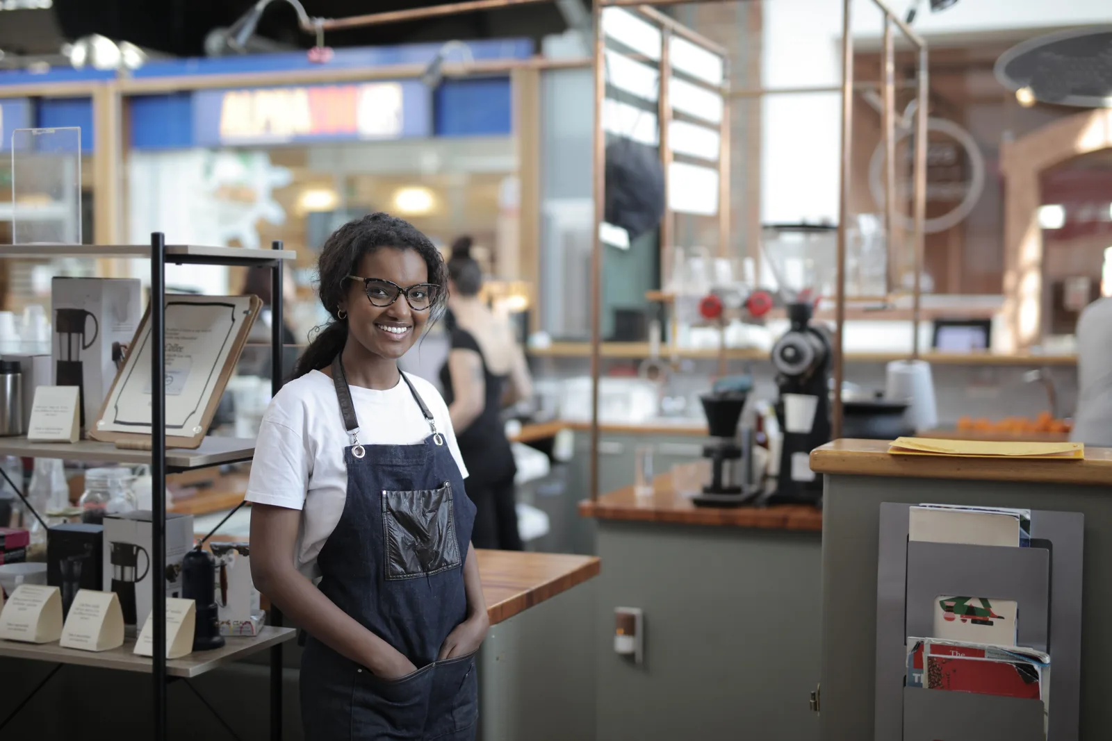 The owner of a small café at work behind the counter