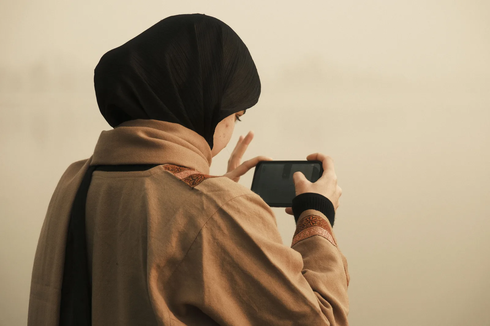 A photographer reviewing their feed on a phone