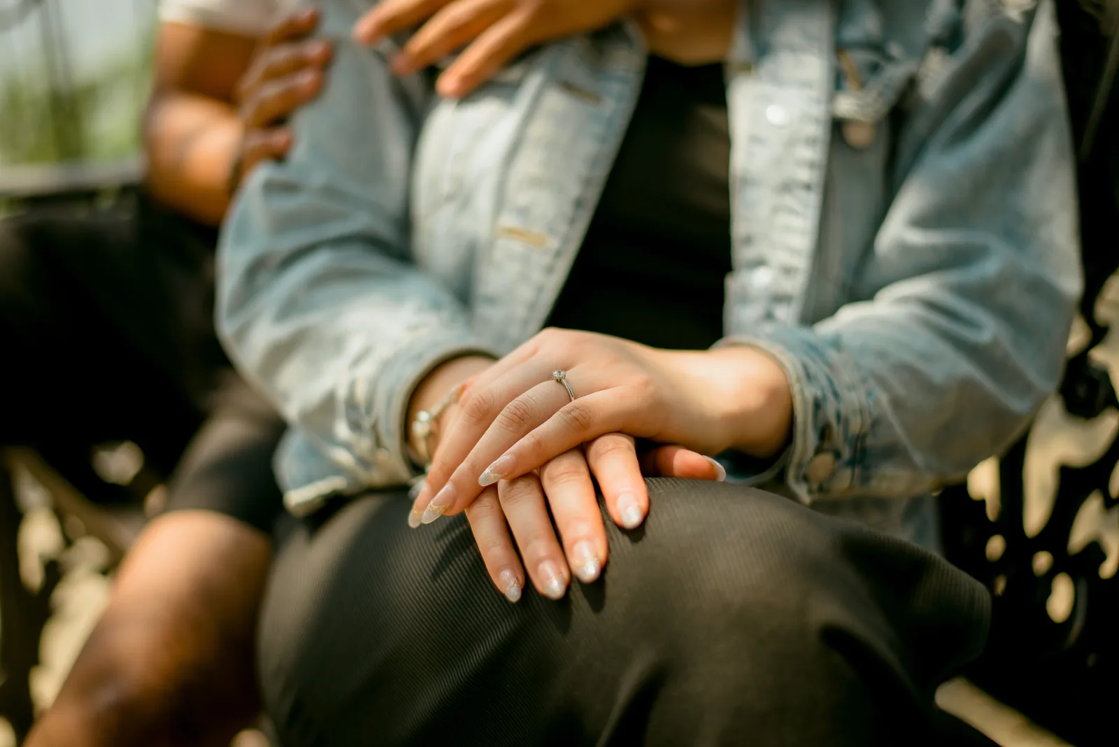 A close up of an engagement ring on a hand after a proposal