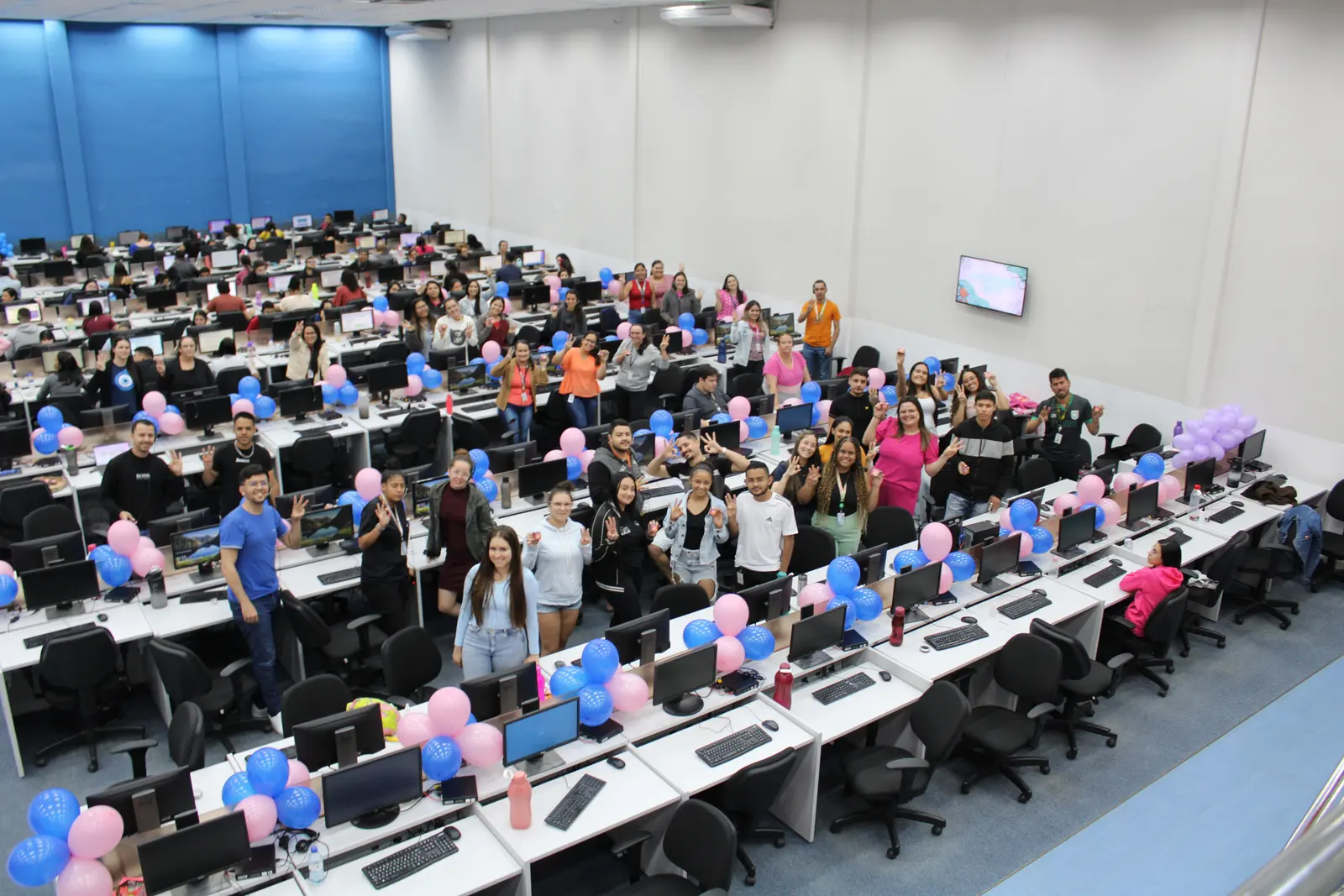 A large group of colleagues photographed from above in an open plan office
