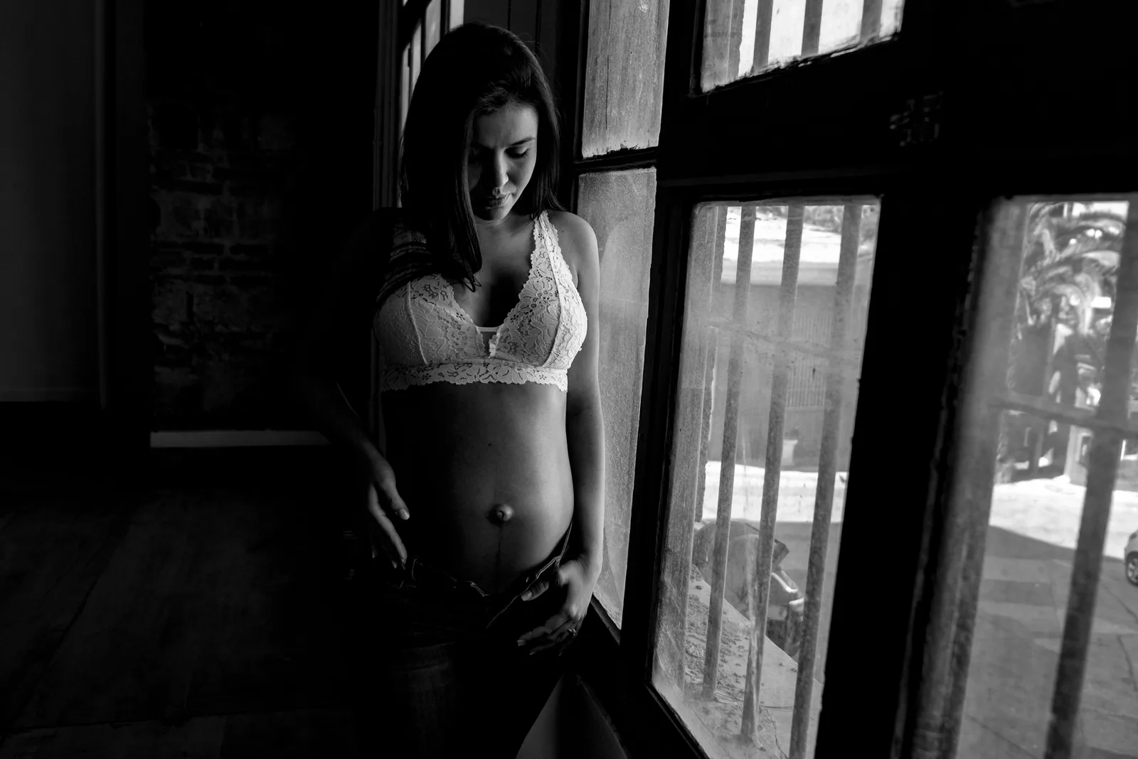 A maternity portrait lit by a large window