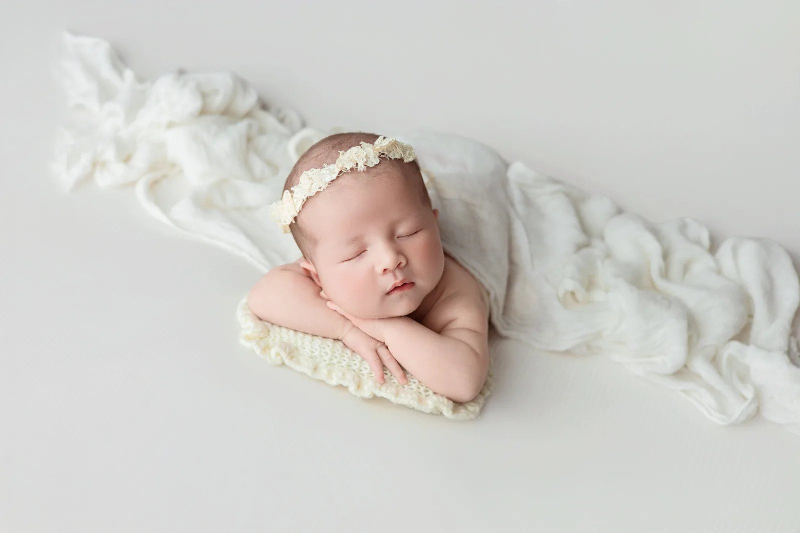 A sleeping newborn wrapped in a soft blanket