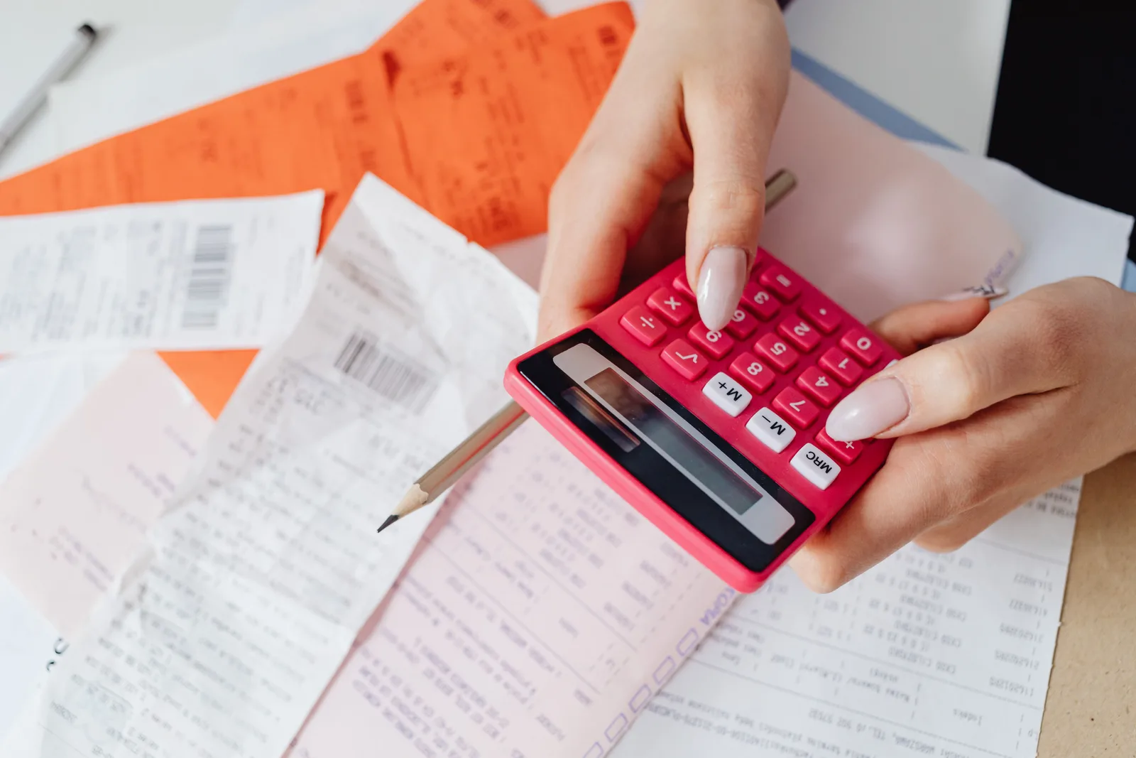 Invoices and a calculator on a work desk