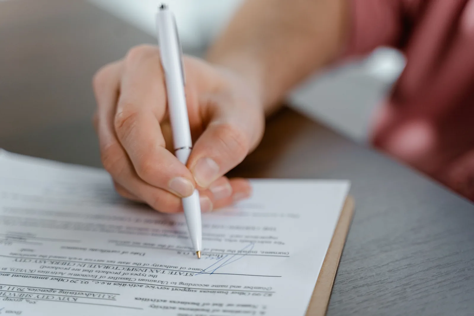 A licence agreement being read and signed at a desk