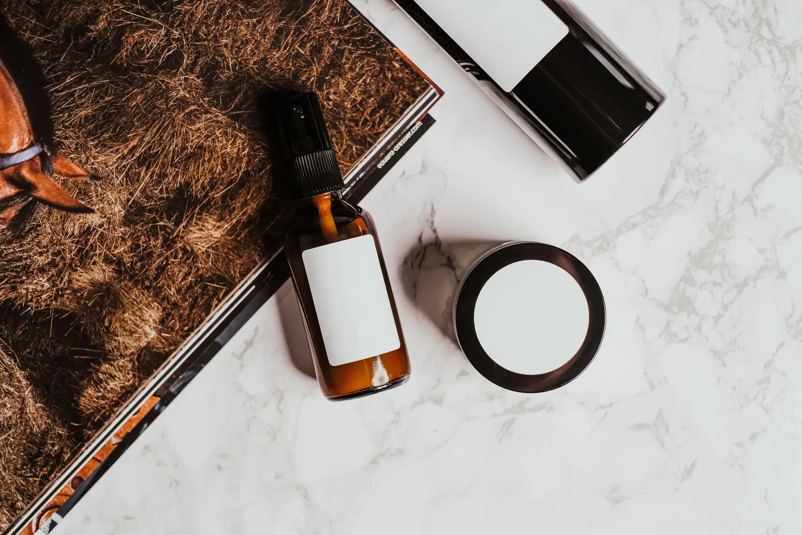 A styled product flat lay on a textured surface