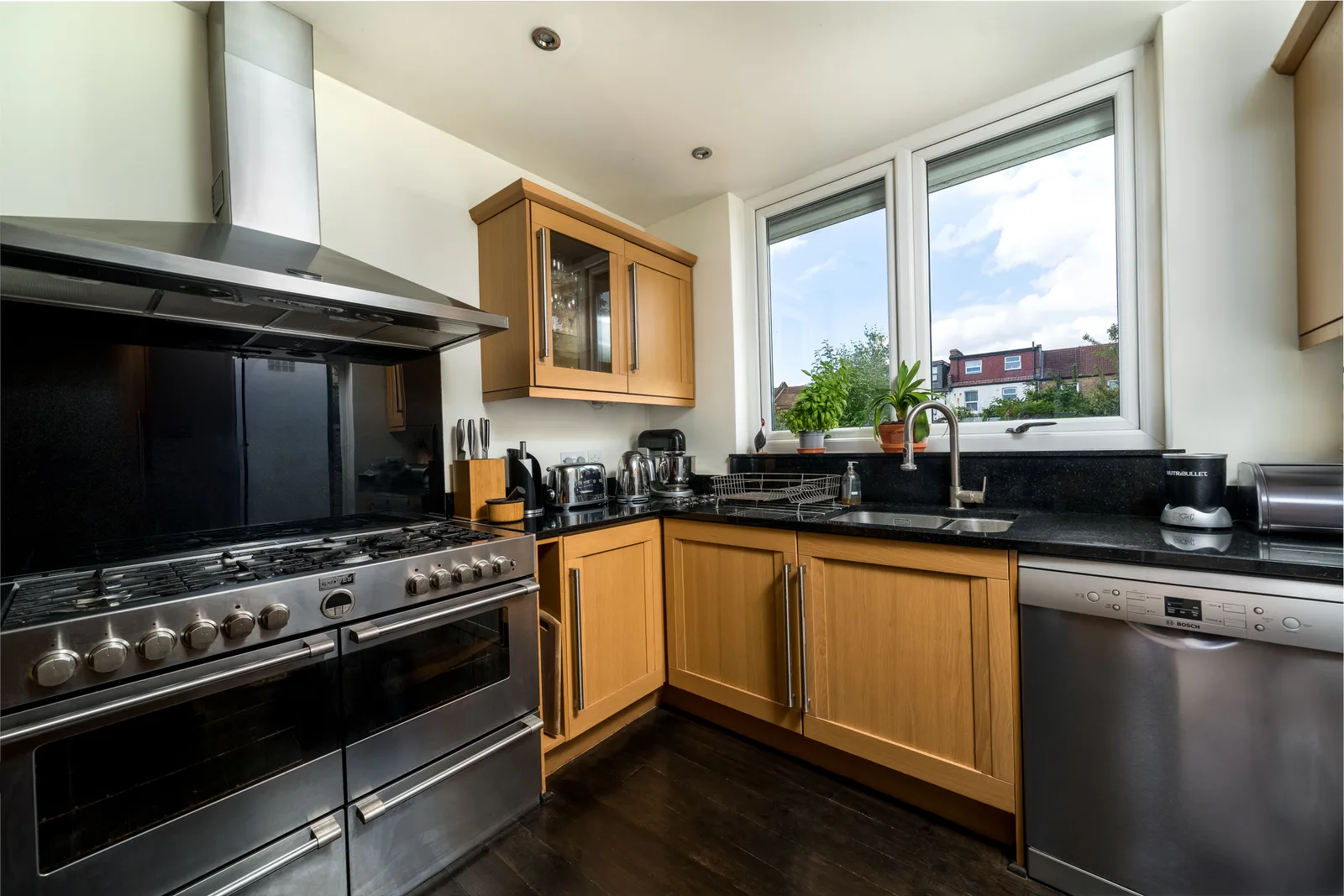 A kitchen photographed wide from the doorway corner