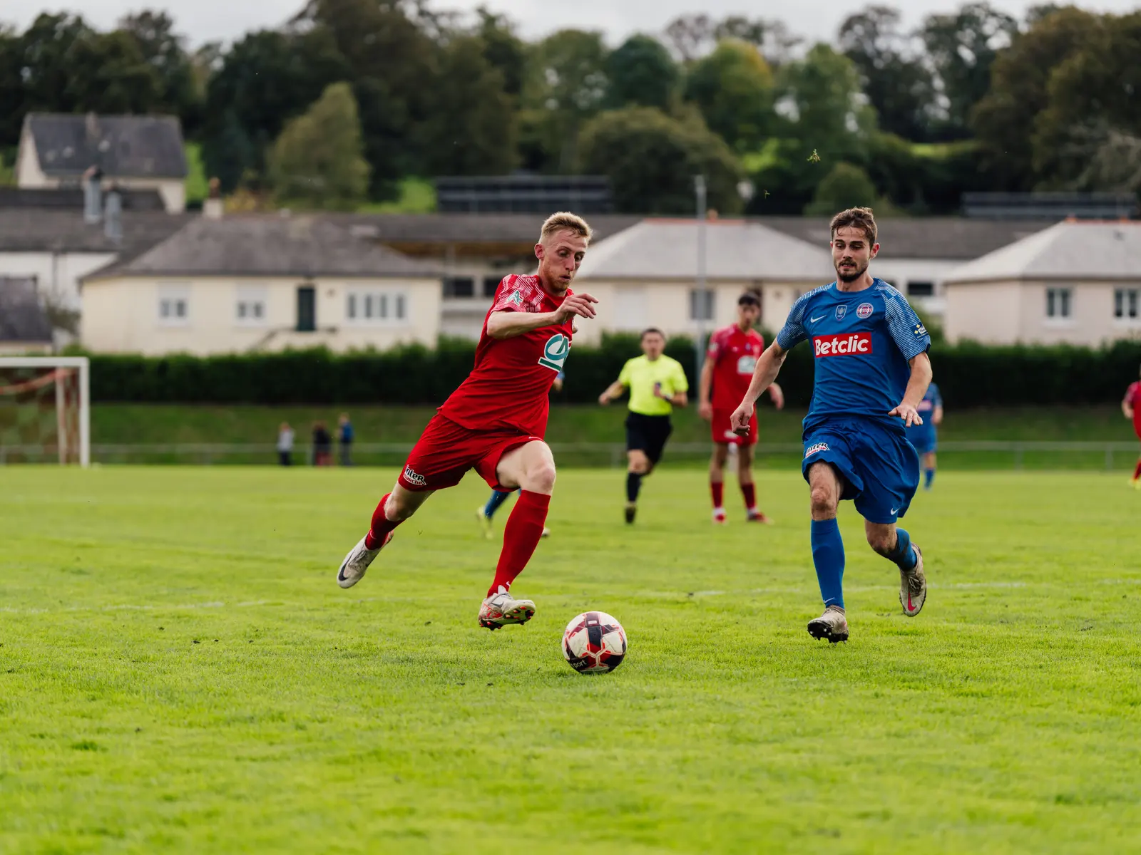 A footballer caught mid stride during a match