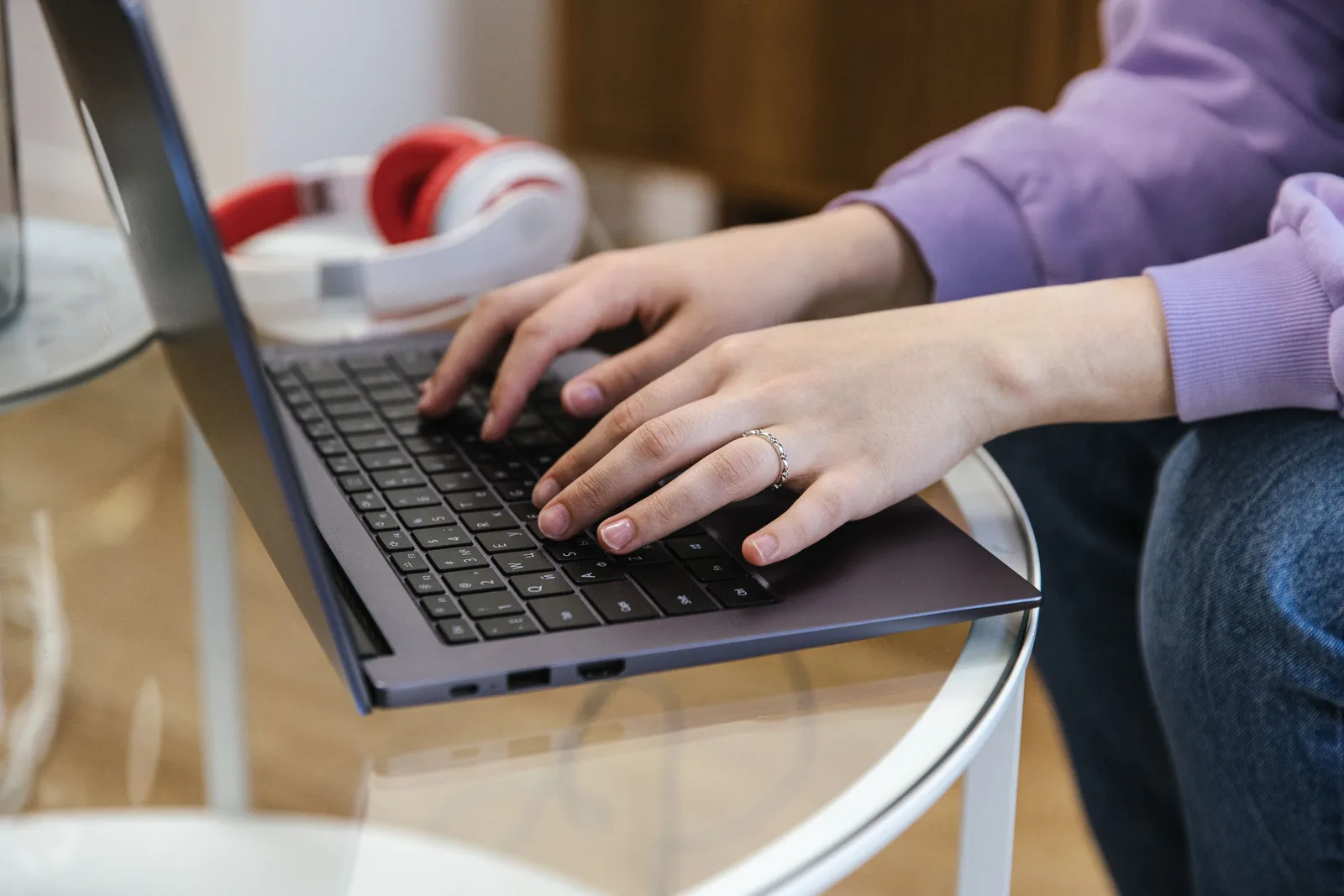Hands typing an email on a laptop