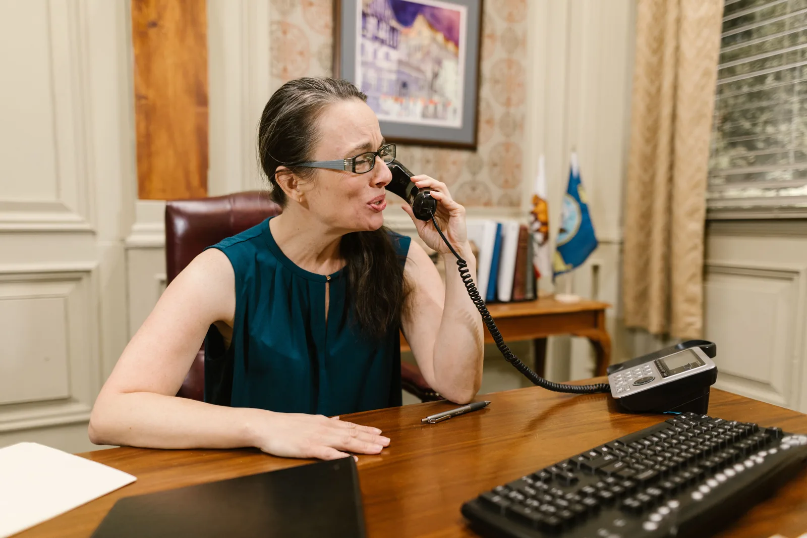A photographer taking a call at their desk