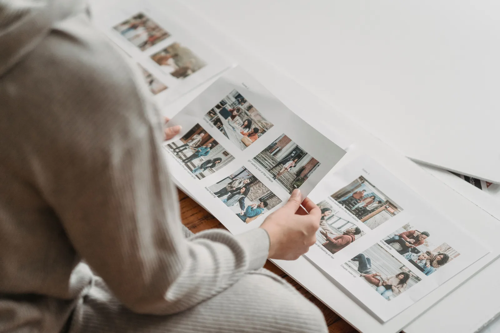 A photographer handing printed photographs to a client
