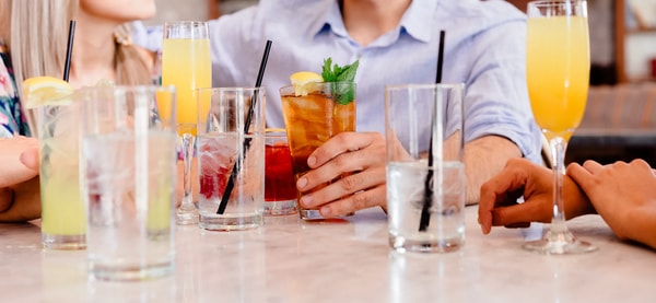 Guests around a bar table with mimosas, iced tea and glasses of water