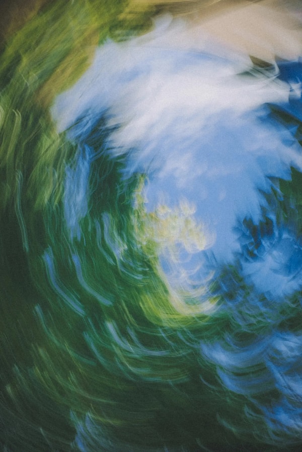 Abstract spin of green foliage and white sky, made with a long exposure