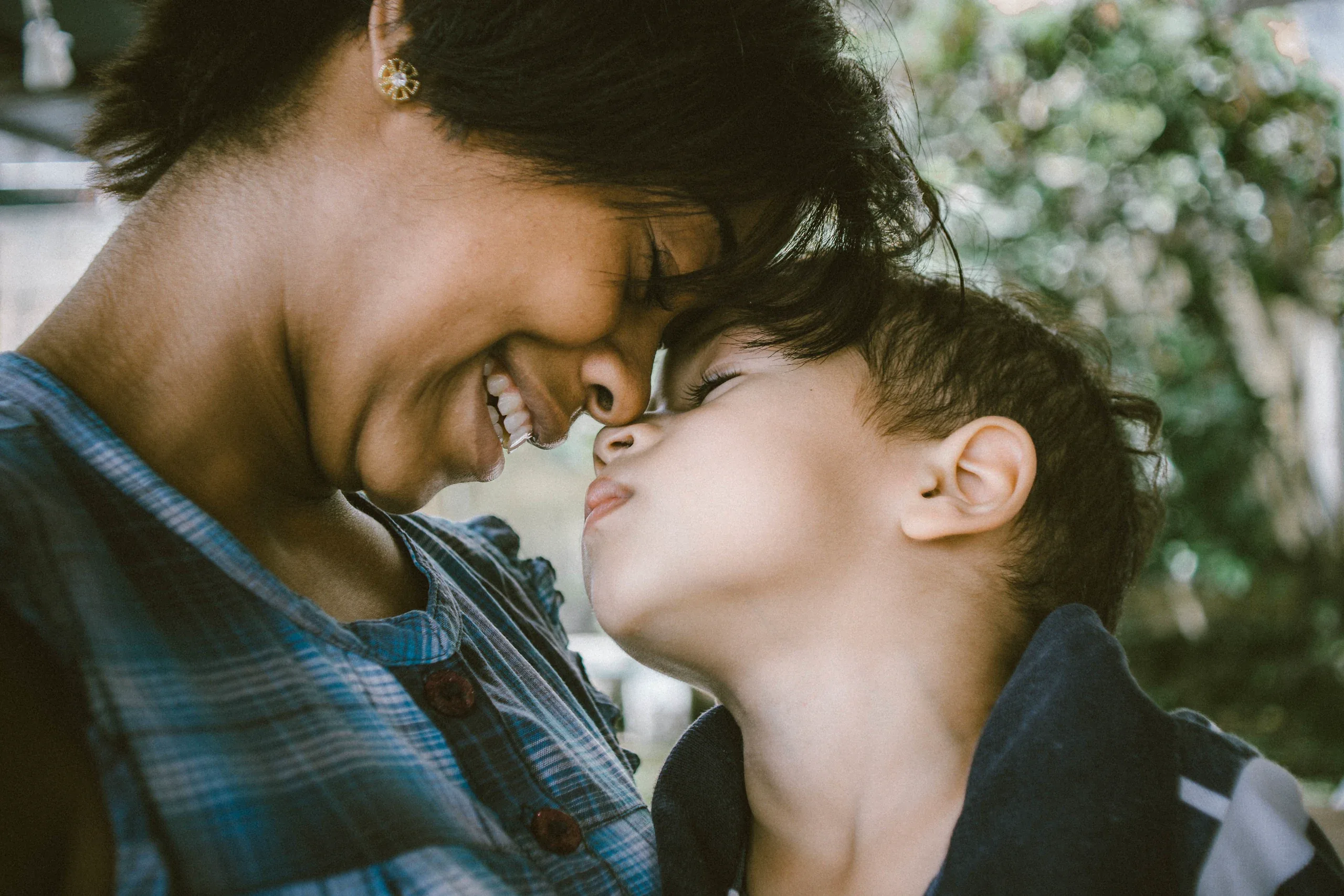 Mother and son touching noses and laughing